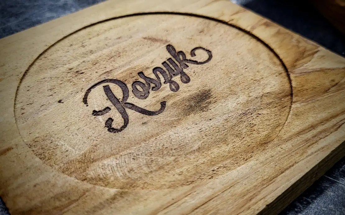 Stack of custom heat-branded cedar coasters